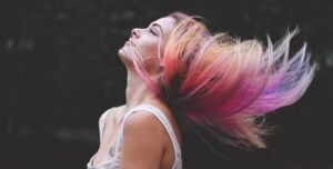 Vibrant multi-colored hair in motion, showcasing bold and creative hair artistry.